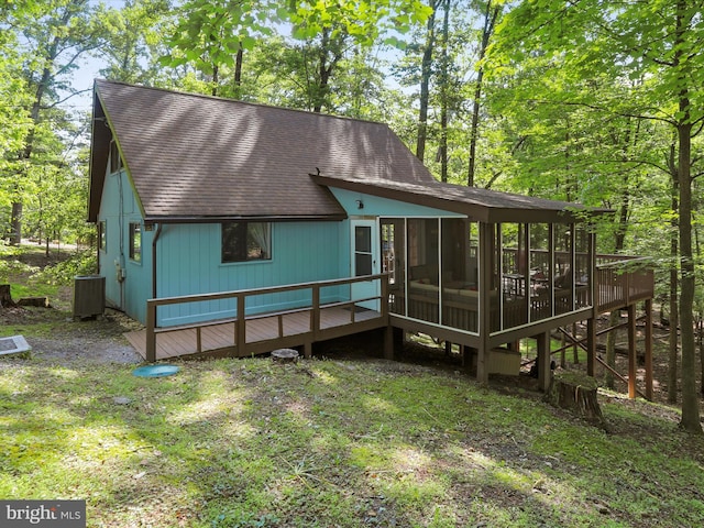 239 Onondaga Trl, Hedgesville, WV 25427 - view of front of house featuring a sunroom, roof with shingles, central AC, and a deck