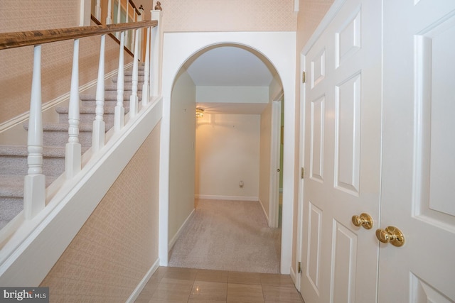 27 Manchester Ct Unit 27, Berwyn, PA 19312 - hallway featuring arched walkways, baseboards, carpet floors, and stairway