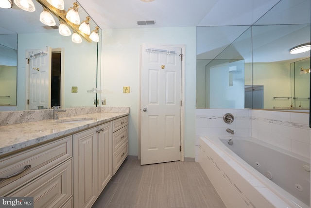 27 Manchester Ct Unit 27, Berwyn, PA 19312 - bathroom featuring a tub with jets, vanity, and baseboards