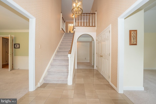 27 Manchester Ct Unit 27, Berwyn, PA 19312 - staircase featuring a chandelier, carpet, ornamental molding, baseboards, and a high ceiling