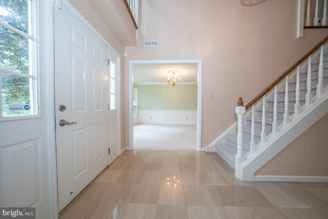 27 Manchester Ct Unit 27, Berwyn, PA 19312 - foyer entrance with a chandelier, baseboards, stairway, plenty of natural light, and crown molding
