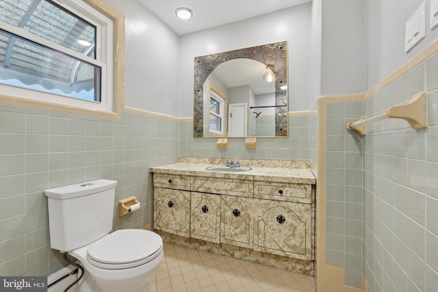 1142 Tree St, Philadelphia, PA 19148 - bathroom with tile walls, toilet, a wainscoted wall, and vanity