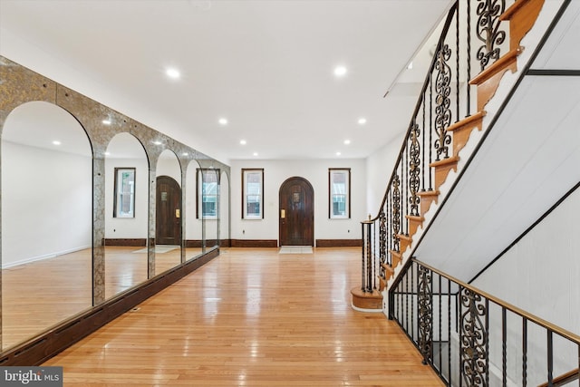 1142 Tree St, Philadelphia, PA 19148 - foyer featuring arched walkways, light wood finished floors, baseboards, recessed lighting, and stairway