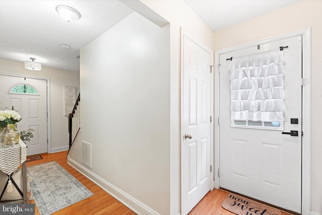 308 Fawn Dr, Winchester, VA 22602 - entrance foyer with light wood finished floors, stairway, and baseboards