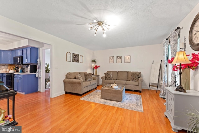 308 Fawn Dr, Winchester, VA 22602 - living area with light wood-type flooring, a chandelier, and a textured ceiling