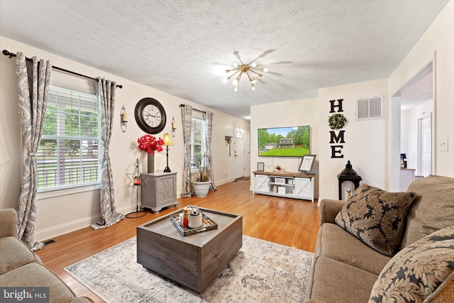308 Fawn Dr, Winchester, VA 22602 - living area with wood finished floors, baseboards, and a textured ceiling