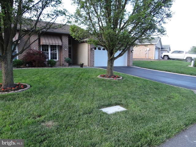 947 Geyer Dr, Chambersburg, PA 17201 - view of front of property with brick siding, a garage, asphalt driveway, and a front lawn