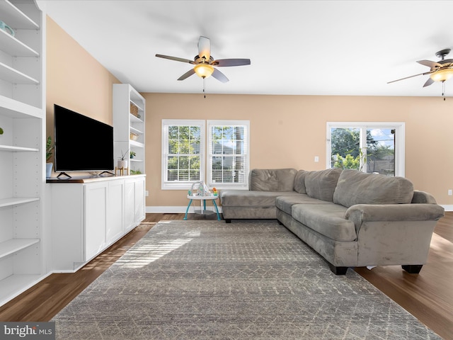 7827 Catherine Ave, Pasadena, MD 21122 - living area with ceiling fan, dark wood finished floors, healthy amount of natural light, and built in shelves