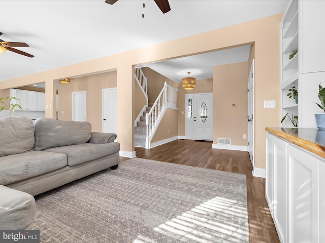 7827 Catherine Ave, Pasadena, MD 21122 - living area with a ceiling fan, dark wood-style floors, and stairs