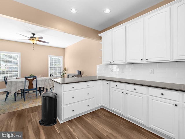 7827 Catherine Ave, Pasadena, MD 21122 - kitchen with dark wood finished floors, a peninsula, backsplash, white cabinetry, and open shelves