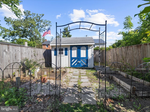 7827 Catherine Ave, Pasadena, MD 21122 - view of shed featuring a vegetable garden and a fenced backyard