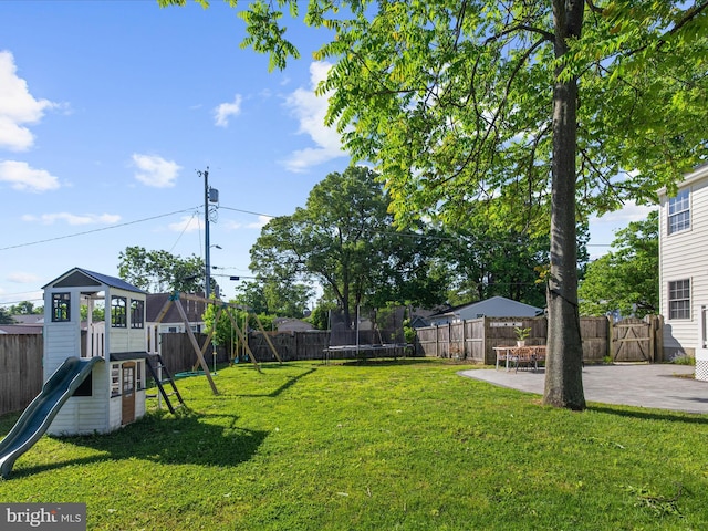 7827 Catherine Ave, Pasadena, MD 21122 - fenced backyard featuring a trampoline, a playground, and a patio