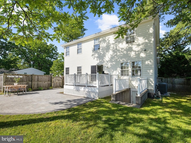 7827 Catherine Ave, Pasadena, MD 21122 - back of house with a fenced backyard, a deck, and a patio