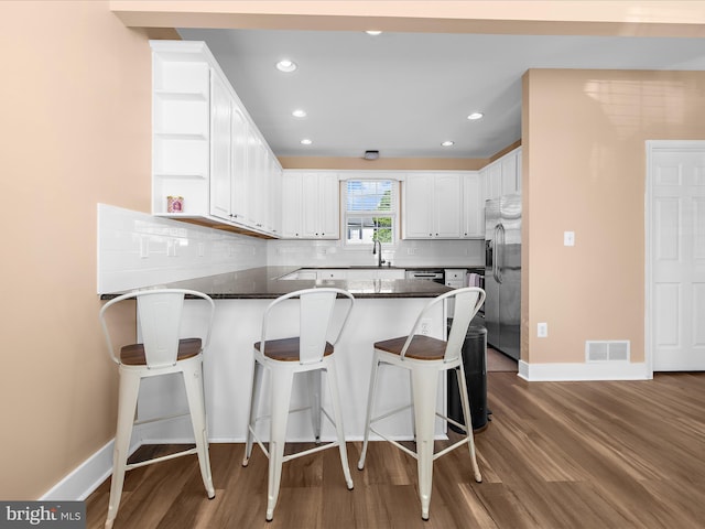 7827 Catherine Ave, Pasadena, MD 21122 - kitchen featuring a peninsula, stainless steel fridge, open shelves, white cabinetry, and recessed lighting