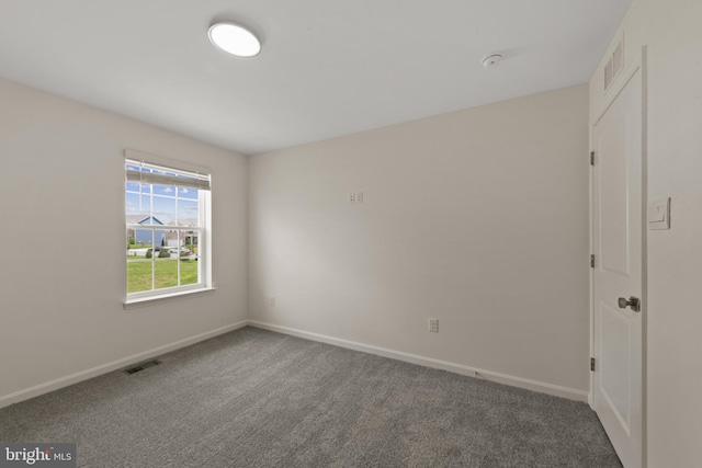 carpeted empty room with baseboards