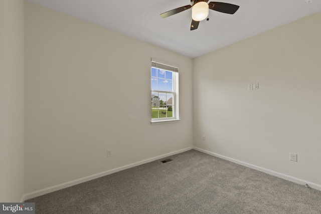 carpeted empty room with baseboards and a ceiling fan