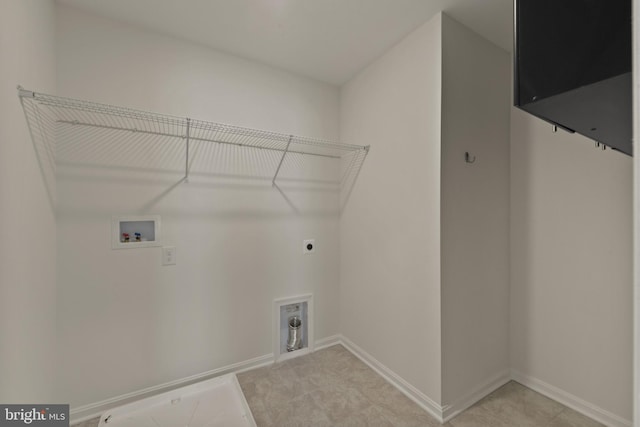 laundry area with hookup for a washing machine, hookup for an electric dryer, and baseboards