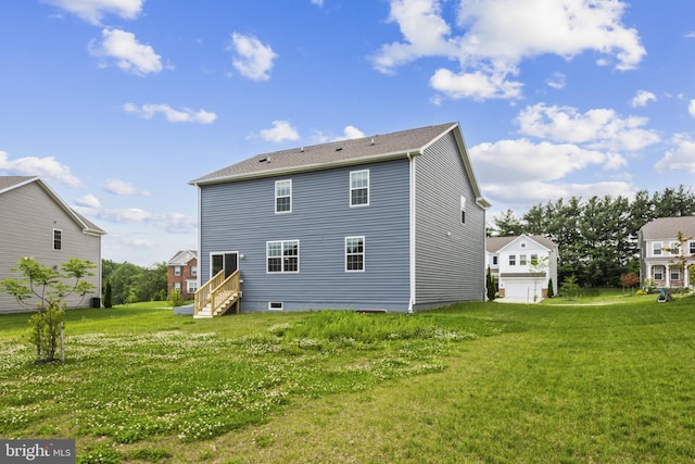back of property with a lawn