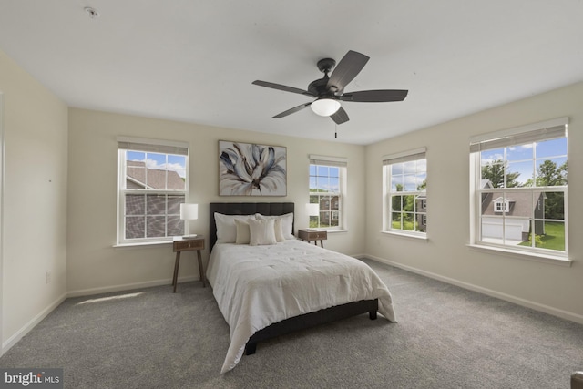 carpeted bedroom with baseboards and a ceiling fan