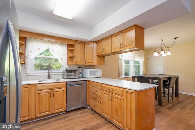 507 Wyndham Rd, Wilmington, DE 19809 - kitchen with stainless steel appliances, a sink, a peninsula, open shelves, and wood finished floors
