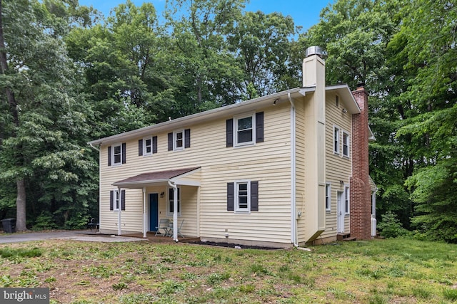 10560 S Faulkner Rd, Faulkner, MD 20632 - view of front facade with a chimney, view of scattered trees, and a patio area