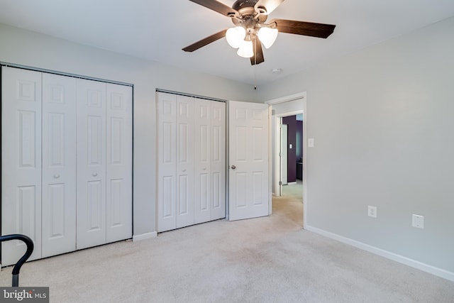 10560 S Faulkner Rd, Faulkner, MD 20632 - unfurnished bedroom featuring multiple closets, carpet floors, baseboards, and ceiling fan