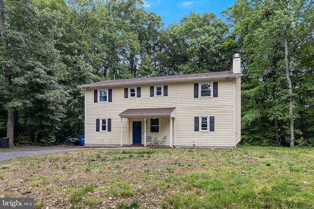 10560 S Faulkner Rd, Faulkner, MD 20632 - colonial-style house with a porch, driveway, a front yard, and a chimney