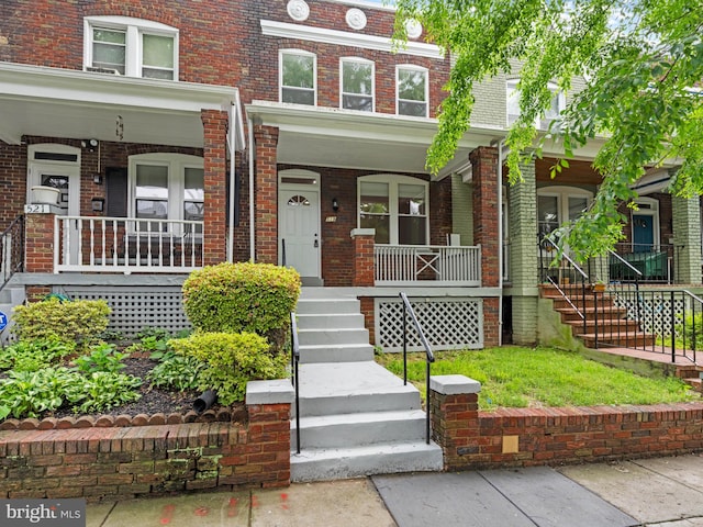 519 23rd Pl NE, Washington, DC 20002 - townhome / multi-family property with covered porch, stairway, and brick siding