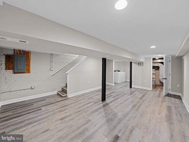 519 23rd Pl NE, Washington, DC 20002 - finished below grade area featuring electric panel, brick wall, baseboards, wood finished floors, and stairway