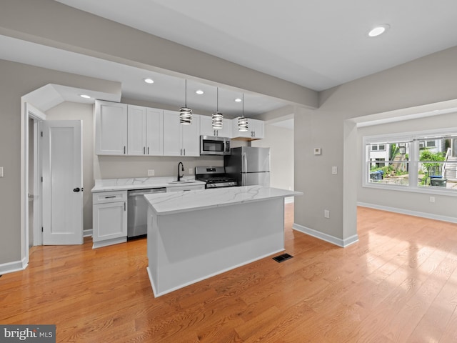 519 23rd Pl NE, Washington, DC 20002 - kitchen featuring appliances with stainless steel finishes, a sink, recessed lighting, decorative light fixtures, and light stone countertops