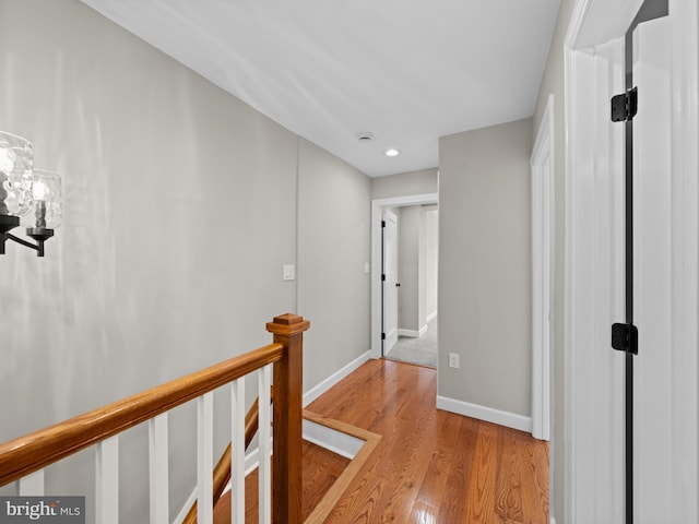 519 23rd Pl NE, Washington, DC 20002 - hallway with an upstairs landing, light wood-type flooring, baseboards, recessed lighting, and a chandelier