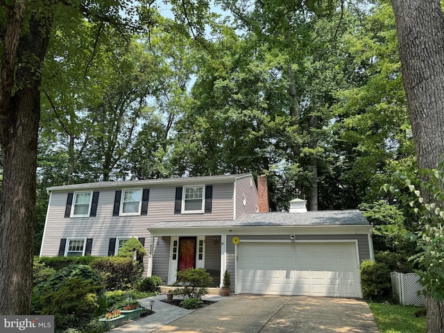 5264 Open Window, Columbia, MD 21044 - view of front facade with driveway, a garage, and a chimney