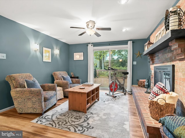 5264 Open Window, Columbia, MD 21044 - living area with wood finished floors, a brick fireplace, and a ceiling fan