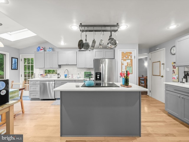 5264 Open Window, Columbia, MD 21044 - kitchen featuring stainless steel appliances, a skylight, light countertops, gray cabinetry, and vaulted ceiling