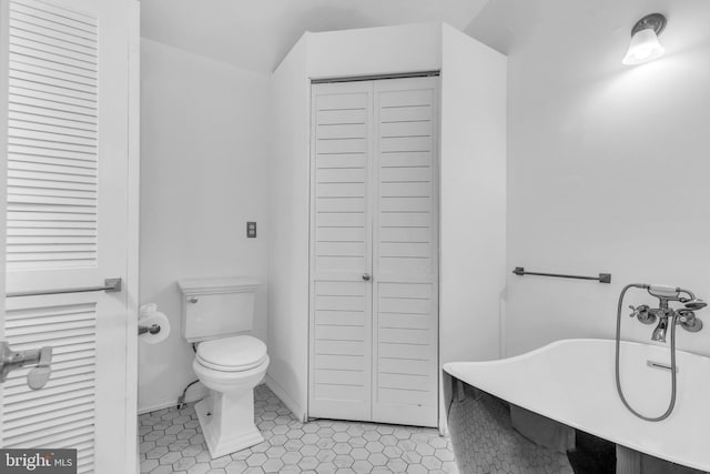 19 Center St, Barnegat, NJ 08005 - bathroom with a closet, toilet, a soaking tub, and tile patterned flooring