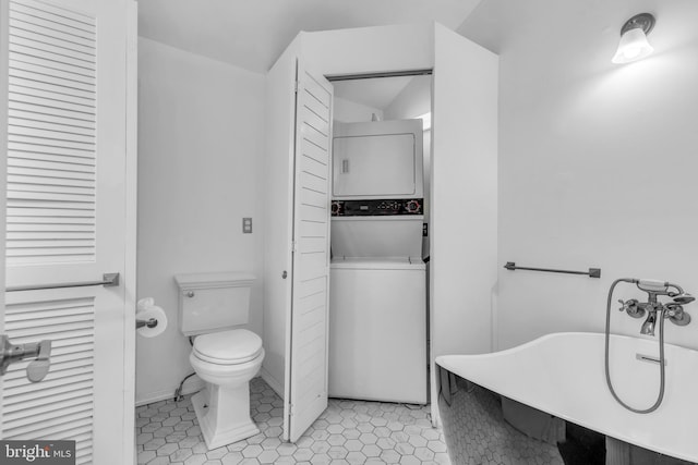 19 Center St, Barnegat, NJ 08005 - bathroom with stacked washing machine and dryer, a freestanding bath, toilet, a closet, and a sink