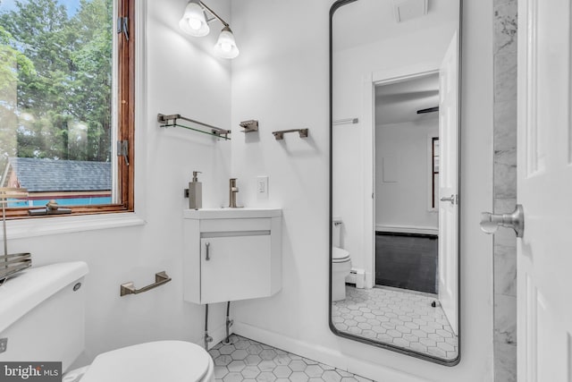 19 Center St, Barnegat, NJ 08005 - half bathroom with toilet, tile patterned floors, a baseboard heating unit, vanity, and baseboards