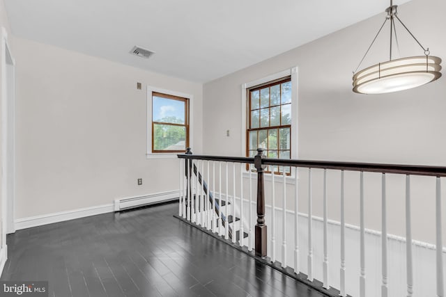 19 Center St, Barnegat, NJ 08005 - corridor featuring baseboard heating, baseboards, an upstairs landing, and wood finished floors