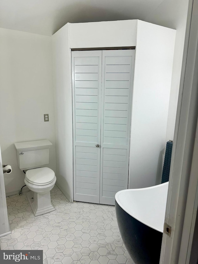 19 Center St, Barnegat, NJ 08005 - bathroom featuring toilet, a closet, baseboards, and a freestanding bath