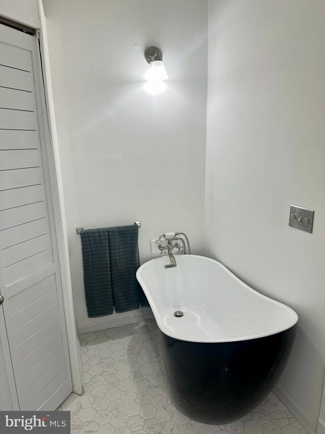 19 Center St, Barnegat, NJ 08005 - bathroom featuring a soaking tub, tile patterned floors, and baseboards