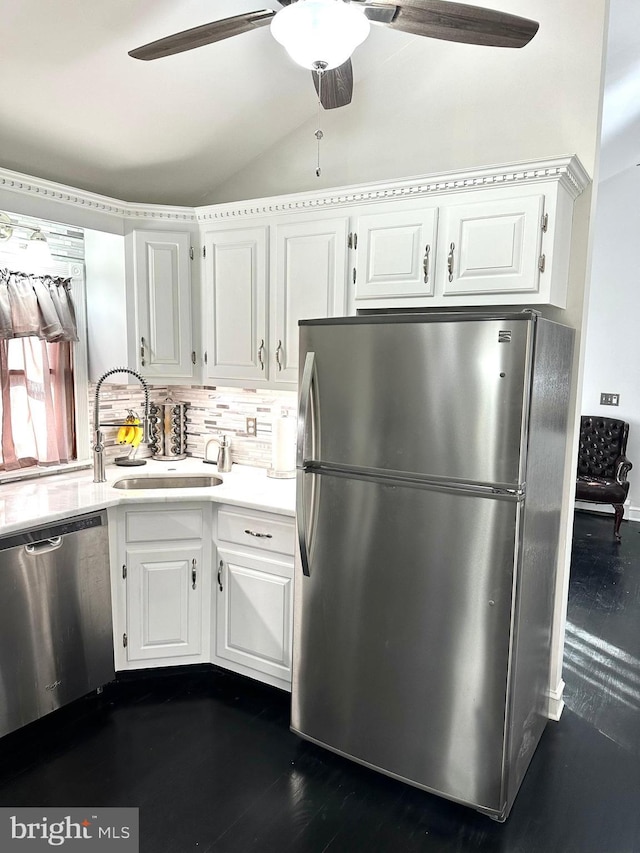 19 Center St, Barnegat, NJ 08005 - kitchen with appliances with stainless steel finishes, a ceiling fan, vaulted ceiling, white cabinetry, and tasteful backsplash