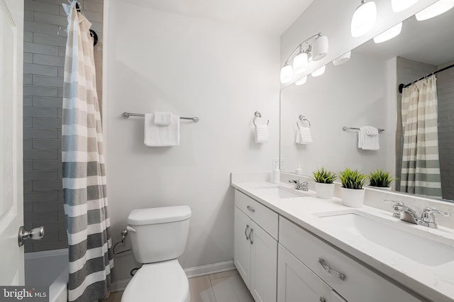 214 S Madeira St S, Baltimore, MD 21231 - full bath with toilet, double vanity, baseboards, shower / tub combo with curtain, and tile patterned floors
