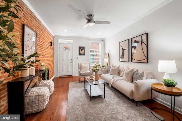 214 S Madeira St S, Baltimore, MD 21231 - living room with ornamental molding, brick wall, a ceiling fan, wood finished floors, and baseboards