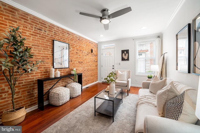 214 S Madeira St S, Baltimore, MD 21231 - living room with brick wall, wood finished floors, ornamental molding, baseboards, and ceiling fan
