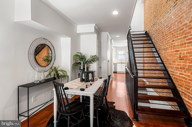 214 S Madeira St S, Baltimore, MD 21231 - dining space with stairway, hardwood / wood-style floors, recessed lighting, and brick wall