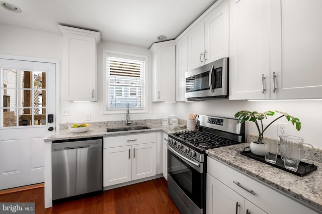 214 S Madeira St S, Baltimore, MD 21231 - kitchen featuring stainless steel appliances, a sink, dark wood-style flooring, and white cabinetry