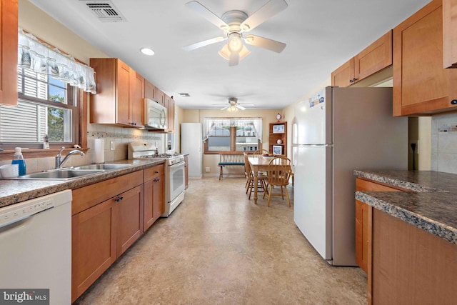 215 W 23rd St, Ship Bottom, NJ 08008 - kitchen with white appliances, a ceiling fan, a sink, healthy amount of natural light, and recessed lighting