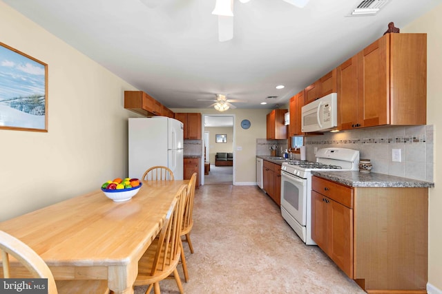 215 W 23rd St, Ship Bottom, NJ 08008 - kitchen featuring white appliances, ceiling fan, tasteful backsplash, brown cabinetry, and light floors