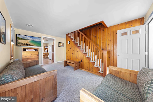 215 W 23rd St, Ship Bottom, NJ 08008 - carpeted living room with stairs, baseboards, and wood walls