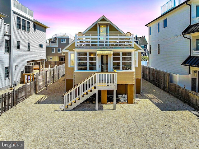 215 W 23rd St, Ship Bottom, NJ 08008 - back of property at dusk featuring a fenced backyard and central air condition unit